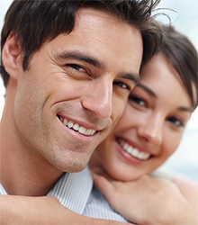 A man and woman smiling after their dentist visit at Kozica Dental in Worcester, MA
